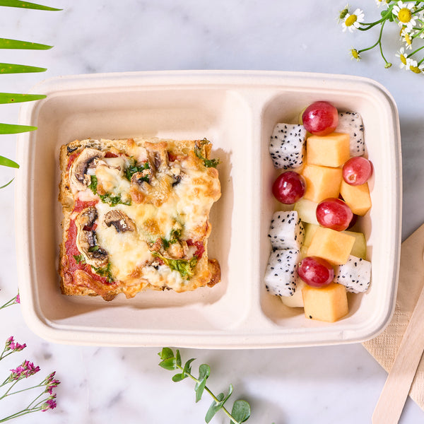 Halal vegetarian focaccia pizza box with a mushroom pizza slice and fresh dragon fruit, melon and grapes