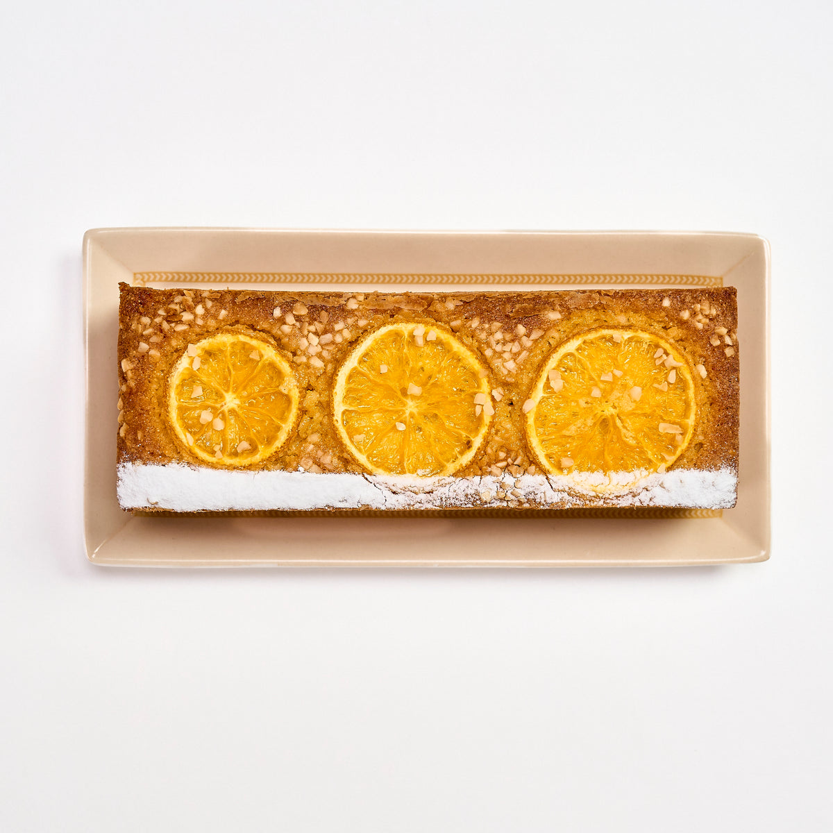 Orange-Infused Sugee Cake topped with candied orange slices and chopped almonds