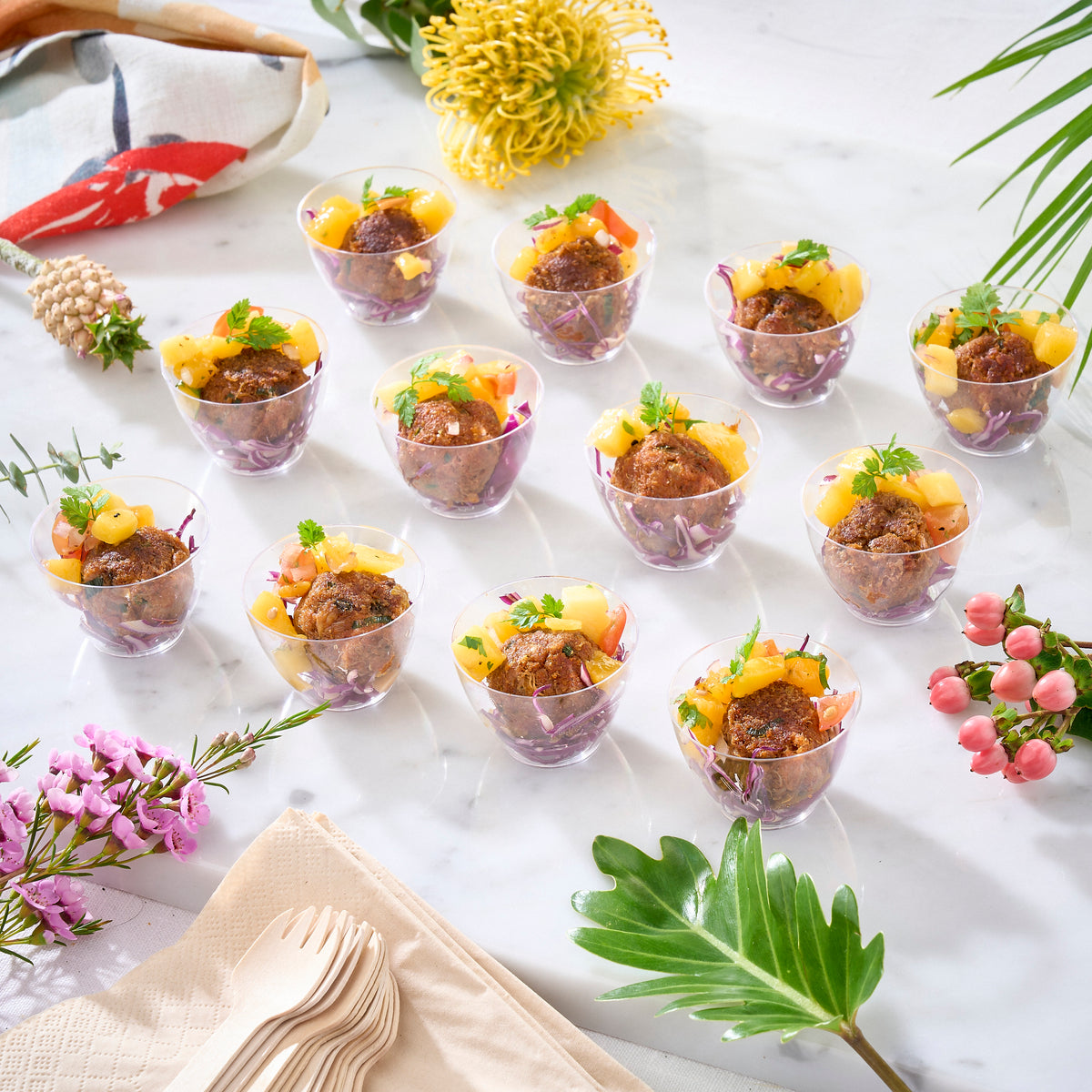 Twelve small clear cups of Mini Crab Cake Mango Salsa