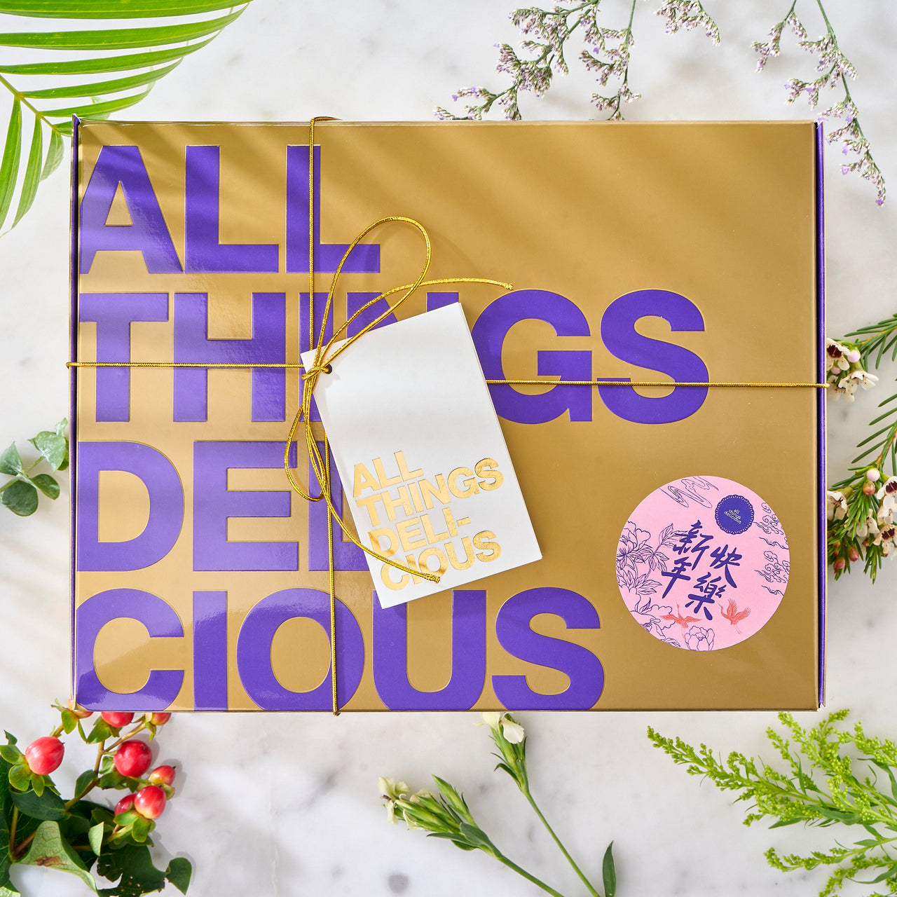 The Abundance Gift Box in gold & purple packaging, labeled with 'All Things Delicious'