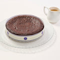 Halal Sticky Toffee Pudding, a whole sticky date sponge in a branded collar, with a jug of toffee sauce