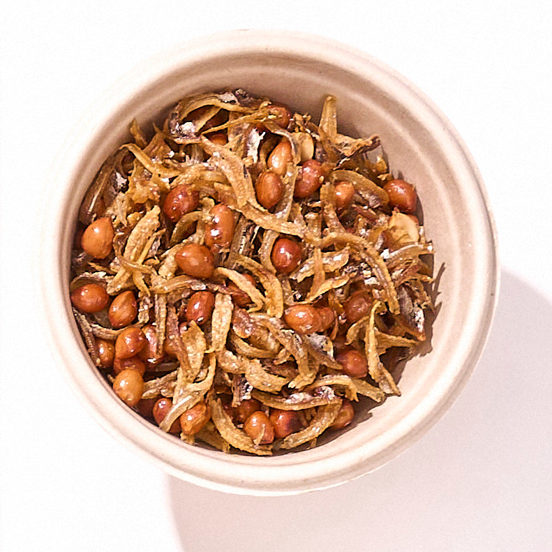 Crispy Ikan Bilis and Peanuts from above in a round bowl, golden fried anchovies tossed with peanuts