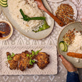 Nasi lemak spread with pandan-knotted coconut rice, ayam goreng berempah, sambal tumis, ikan bilis and cucumber