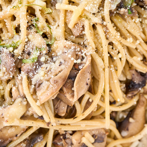 Close-up of Aglio Olio pasta with mushrooms and vegan parmesan