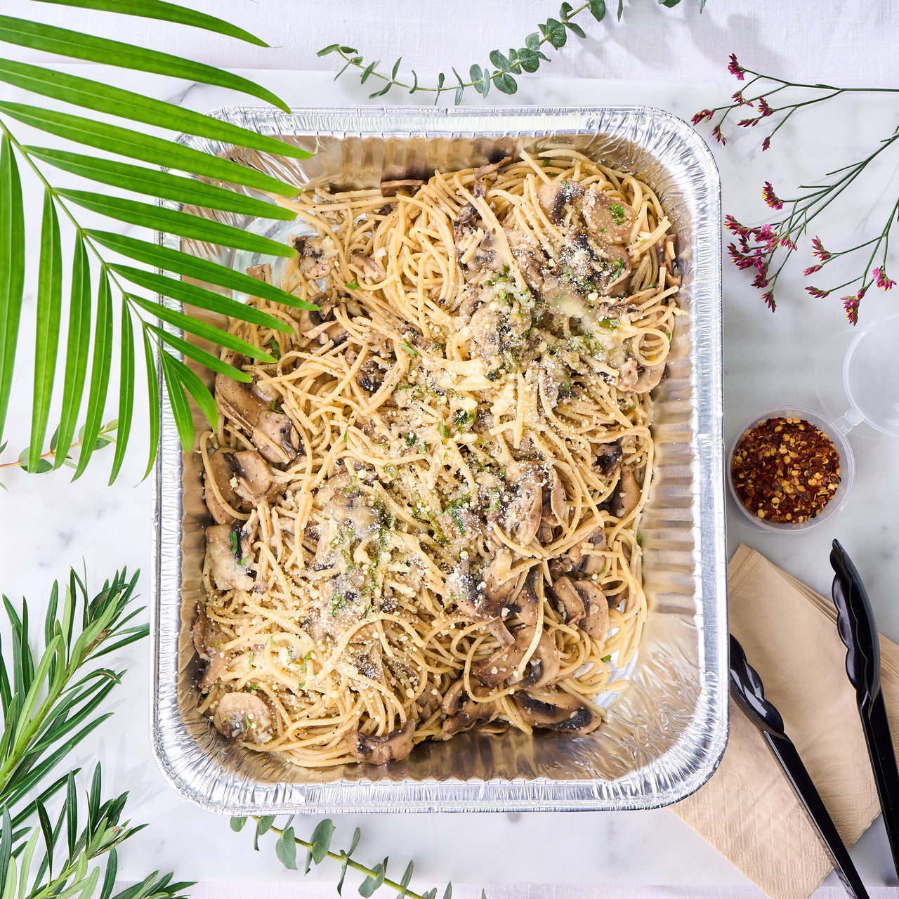 Aglio Olio with mushrooms pasta served in a catering tray