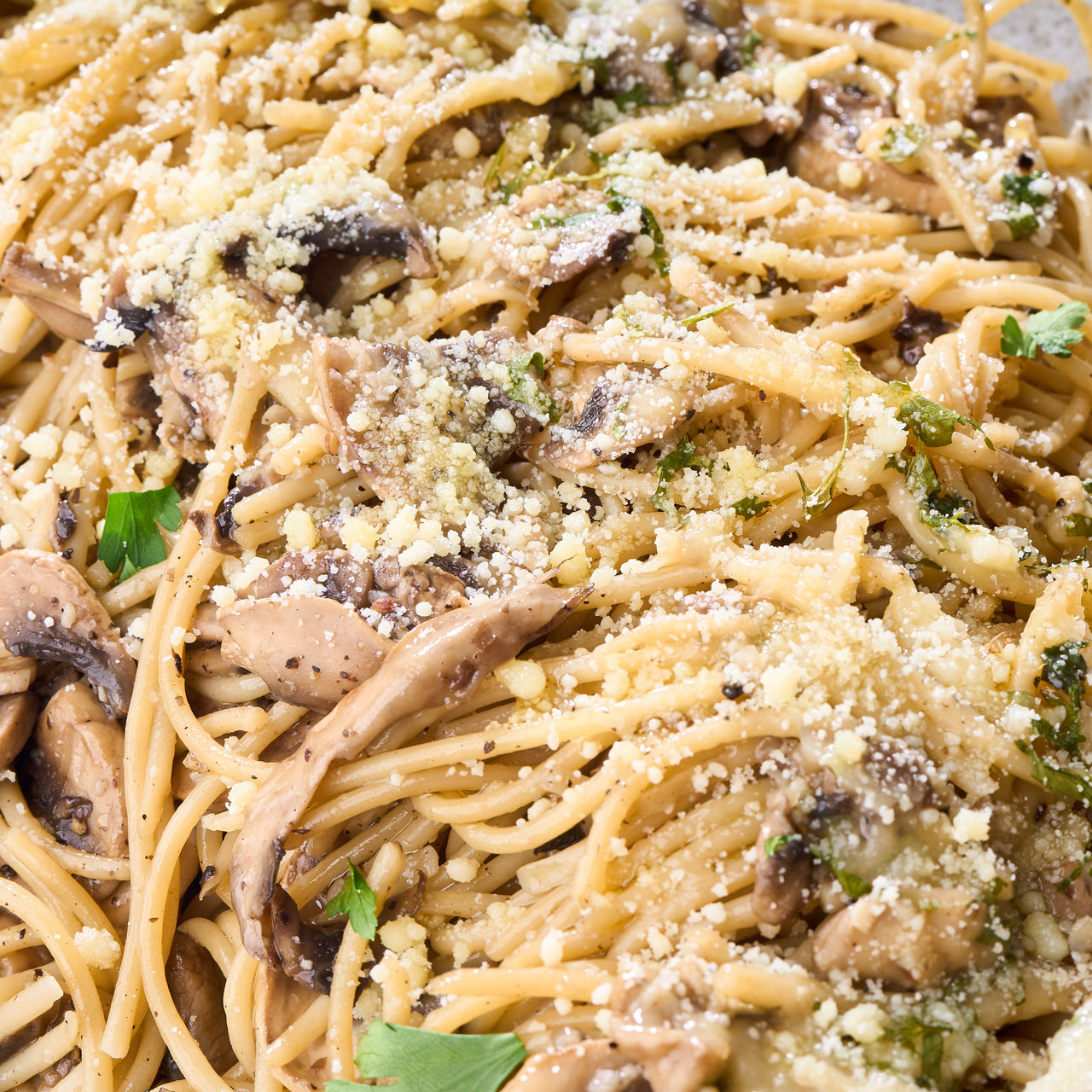 Top view of a tray of Aglio Olio mushroom pasta suitable for vegetarians