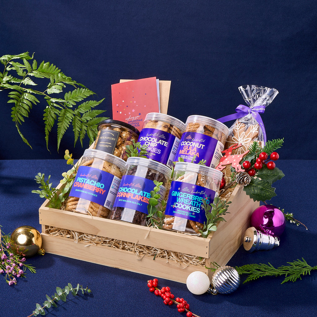 A Christmas hamper full of assorted cookie jars and pop corn, including  gingerbread wreaths and snowflakes.