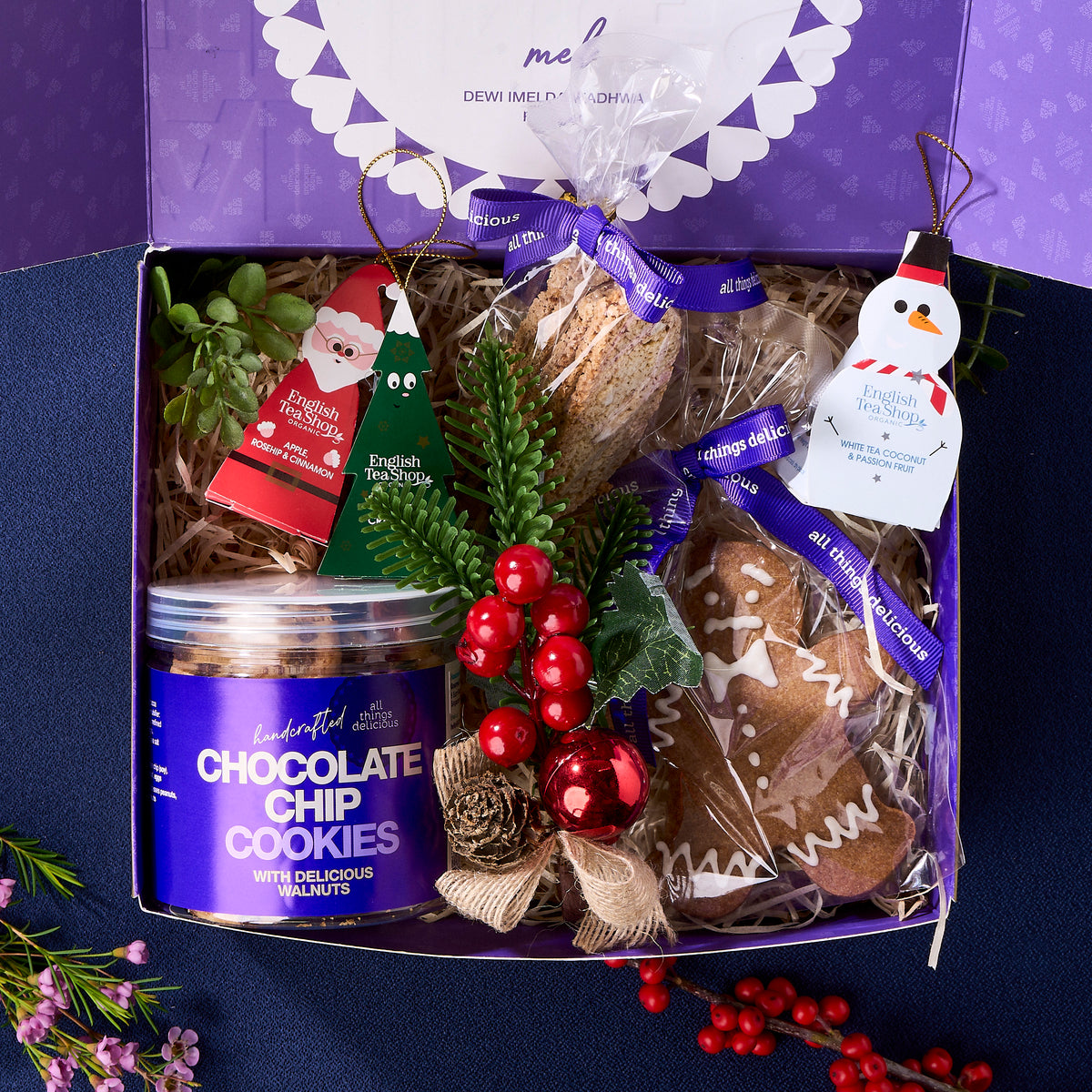 Golden Christmas gift box with jar or cookie, biscotti, teas and a ginger bread man. 