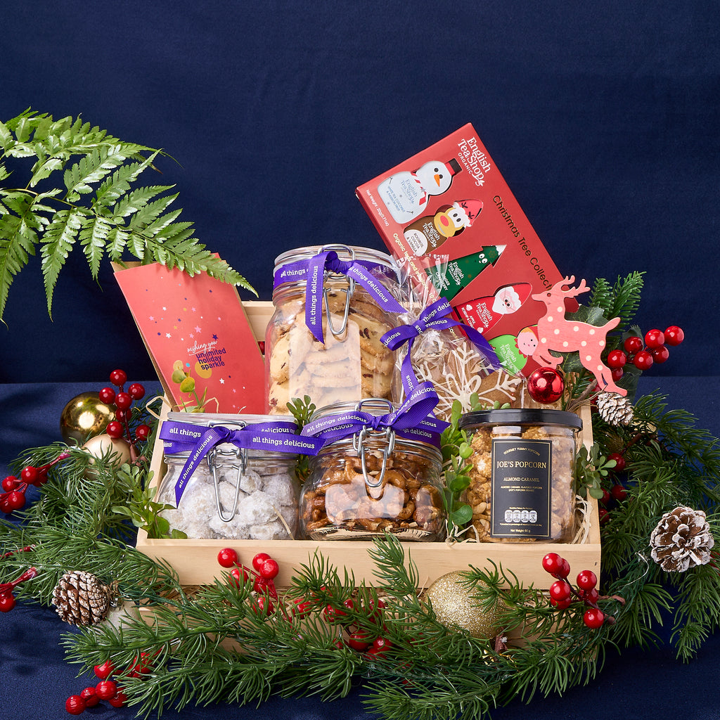 Christmas Hamper with glass jars of assorted cookies, set of organic teas and a greeting card.