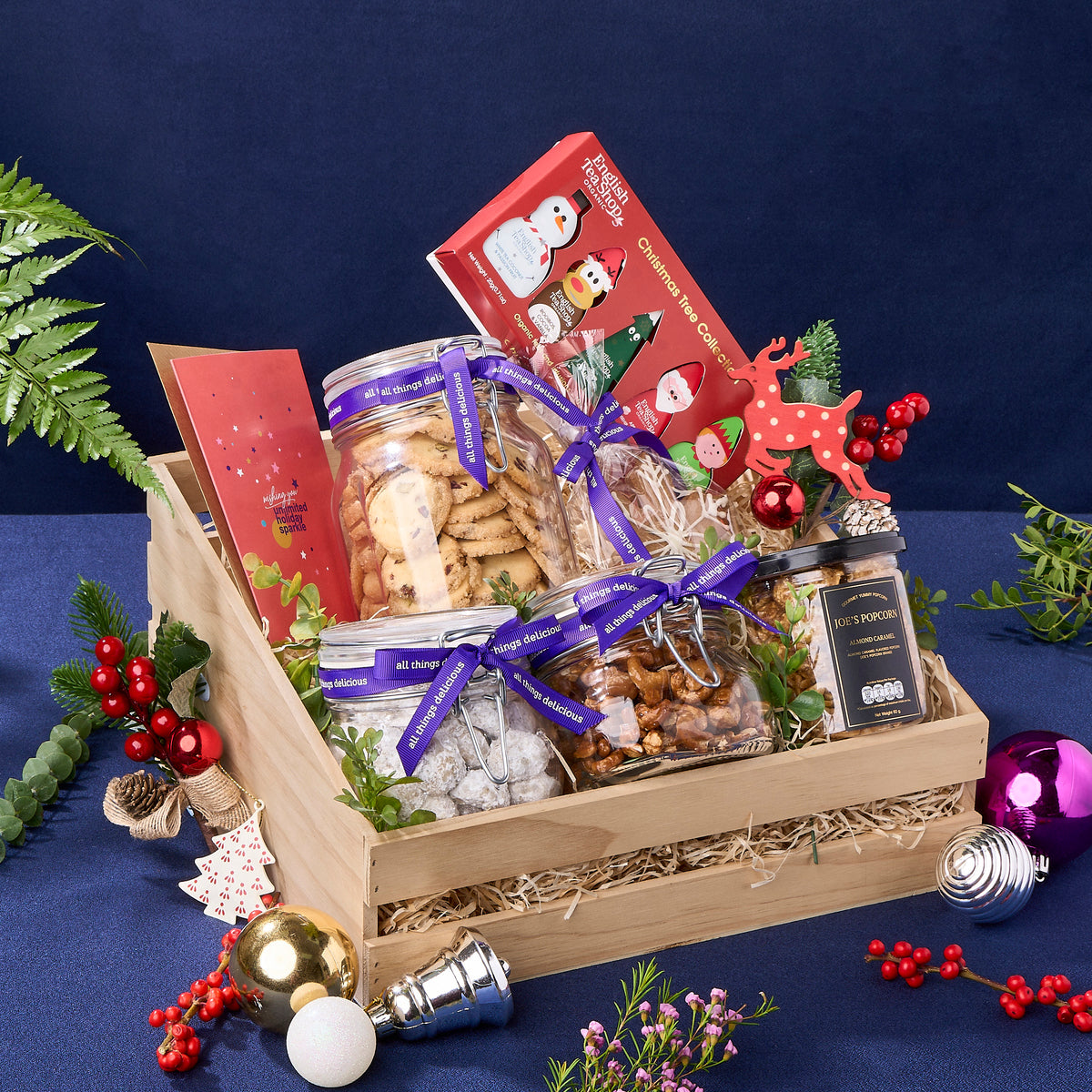 Christmas Hamper with glass jars of assorted cookies, set of organic teas and a greeting card.