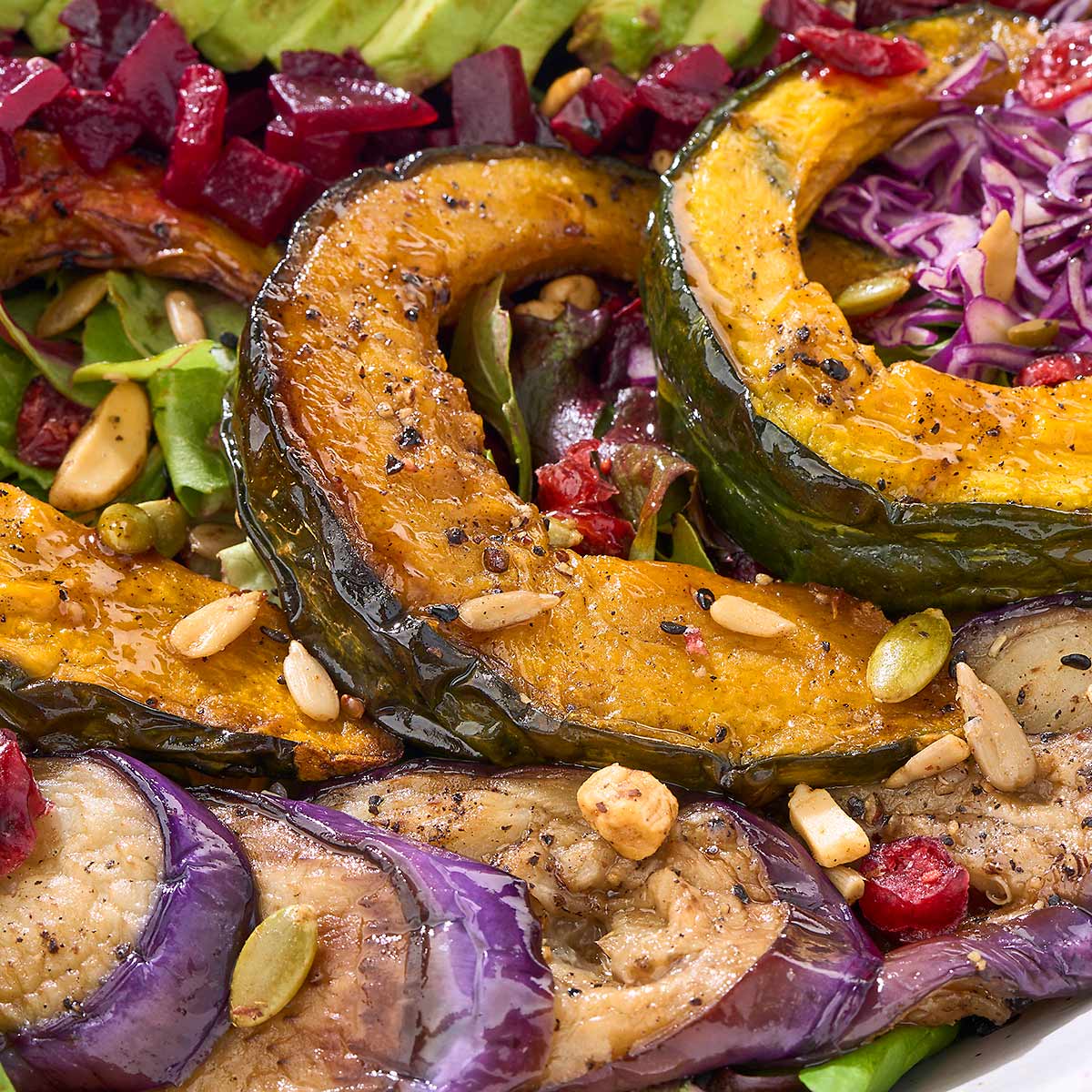 Roasted kabocha squash or Japanese pumpkin, glistening over the salad
