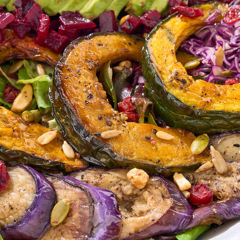 Roasted kabocha squash or Japanese pumpkin, glistening over the salad